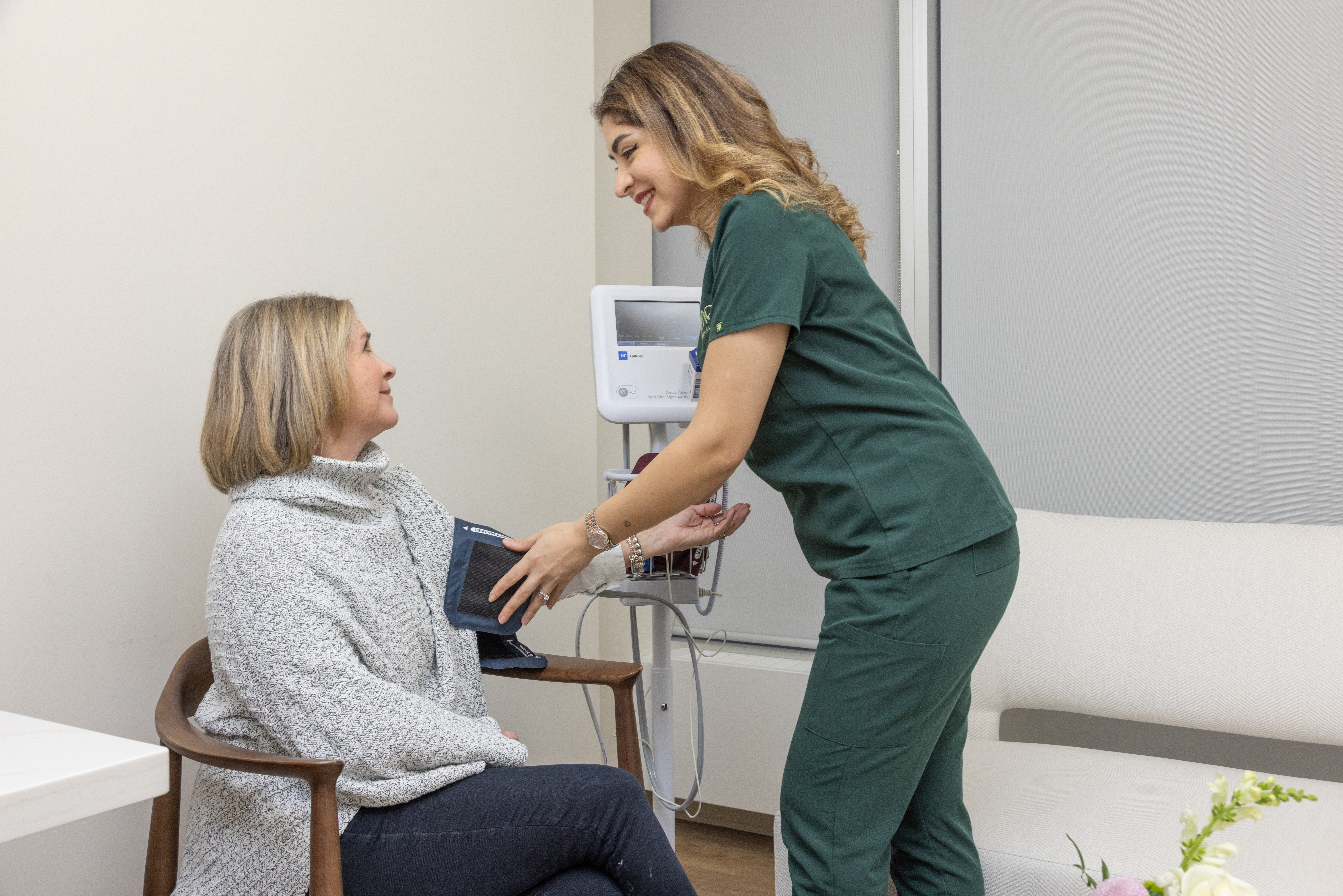 Nurse taking woman's blood pressure Nurse taking woman's blood pressure